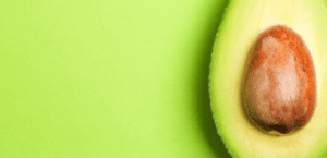 A close up of an avocado on a green surface