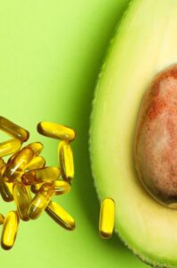 A close up of an avocado and some fish oil