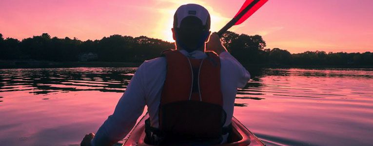 A man in a canoe holding onto a paddle