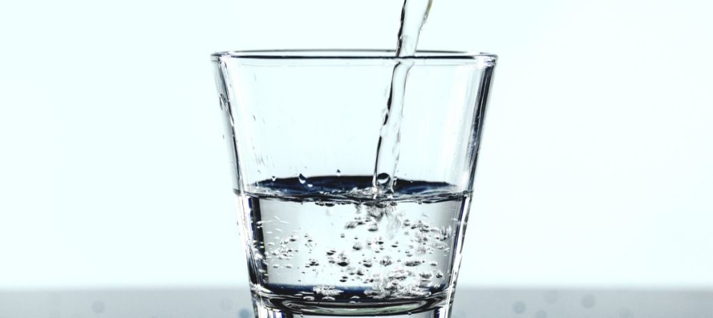 A glass of water is being poured into it.