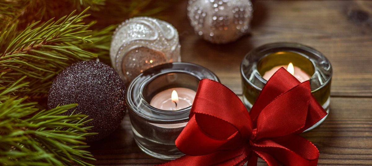 A candle with a red bow on it