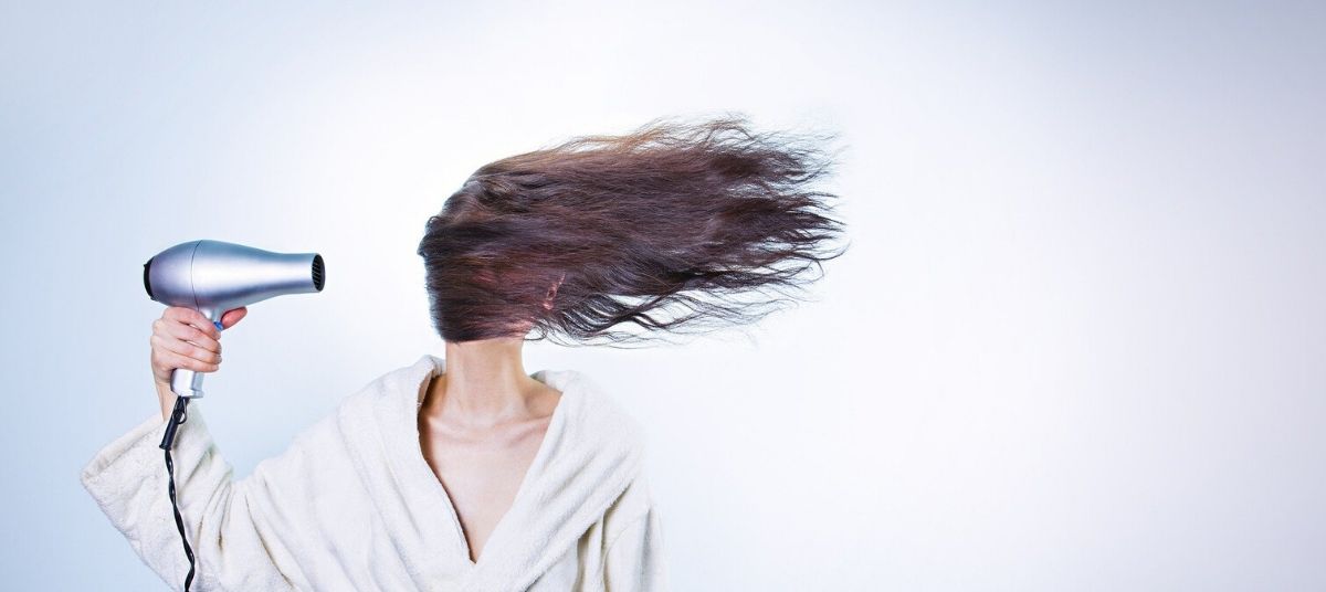 A woman with long hair flying in the wind.