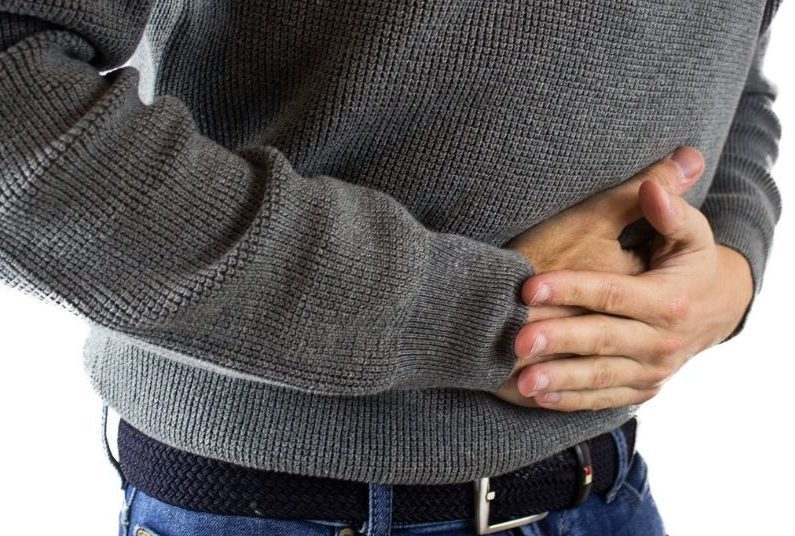 A person with their hands in his stomach.