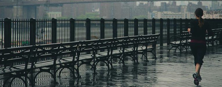 A row of benches sitting in the water.