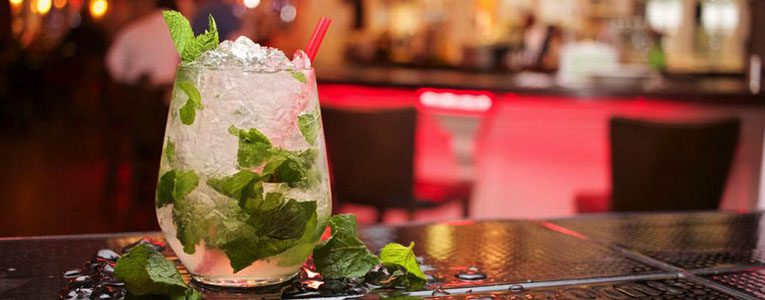 A glass of mojito on the table in a bar.