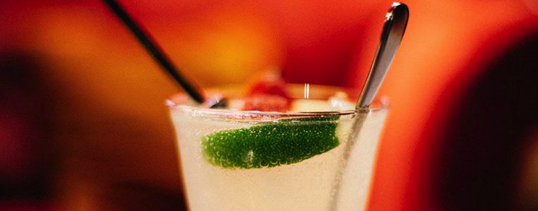 A close up of a drink with lime and ice