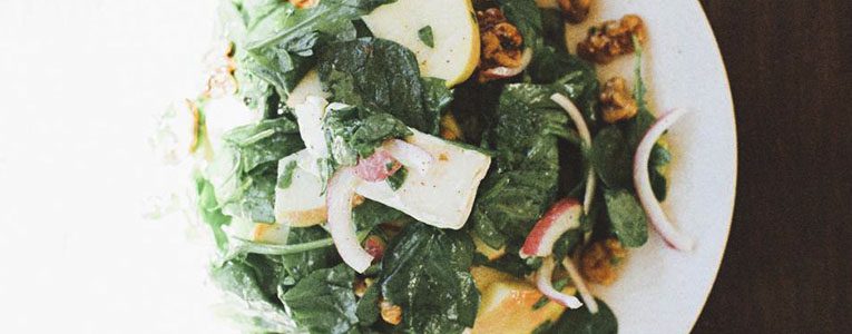 A close up of the salad with apples and nuts