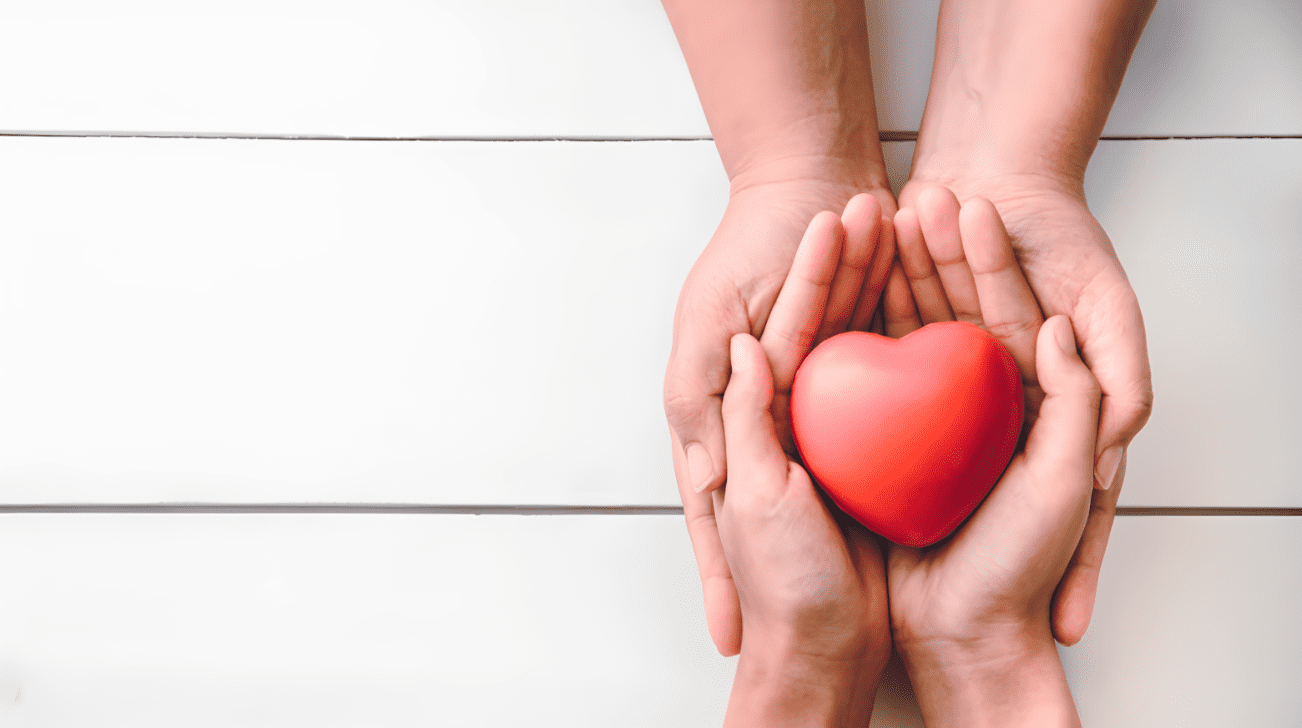 A person holding a heart in their hands.