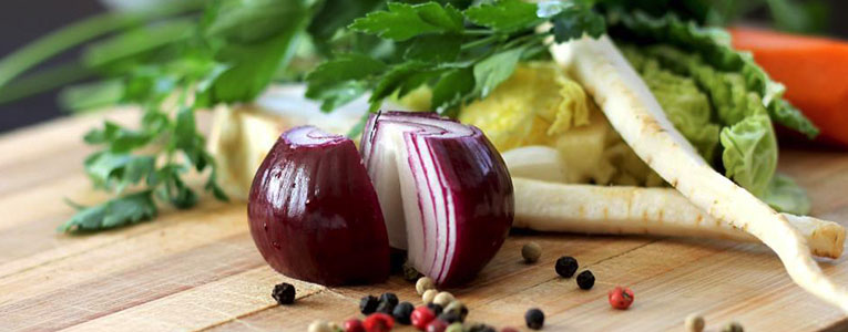 A close up of sliced onions on top of a cutting board.