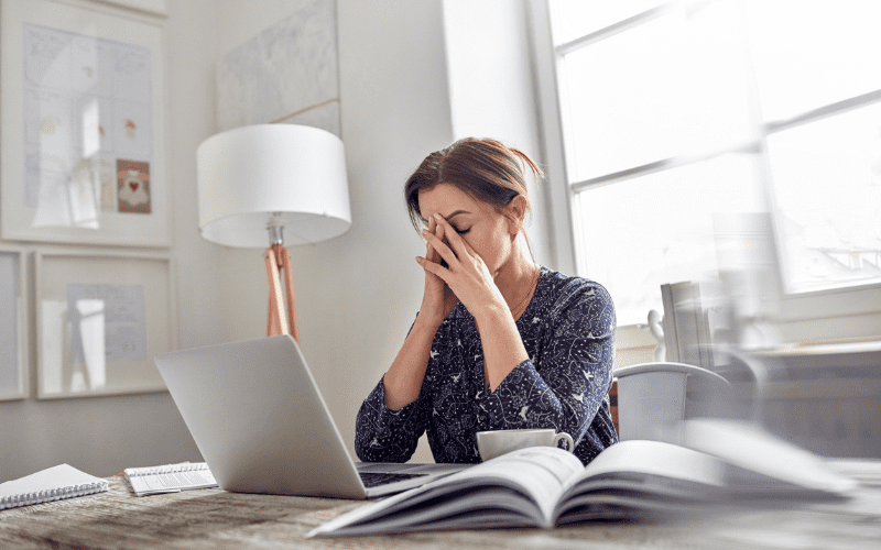 A woman sitting at her desk with a laptop.