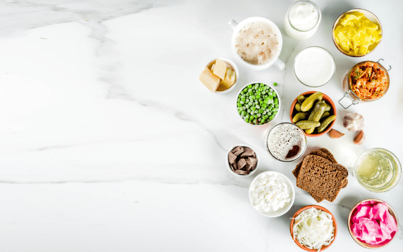 A white table topped with bowls of food and milk.